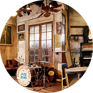 Photo of a stage with a drum kit inside Preservation Hall